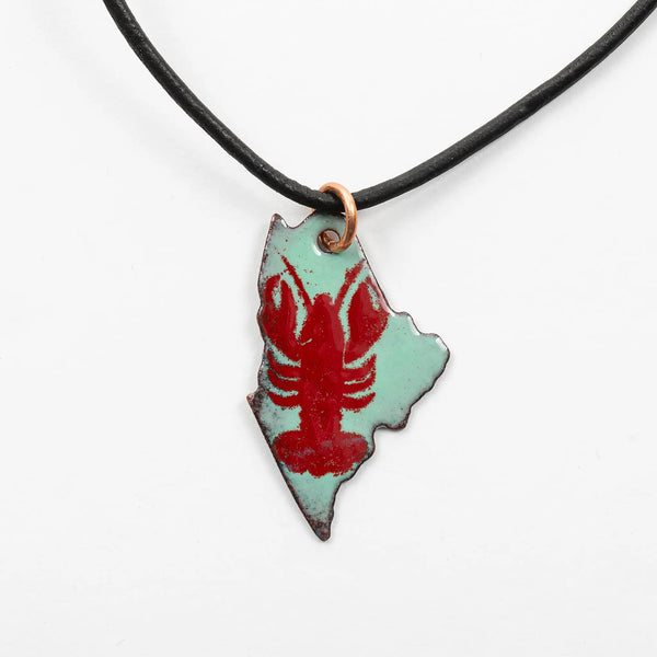Blueberry Bay Jewelry seafoam green state of Maine copper enameled necklace hangs from a black leather cord with a red lobster design