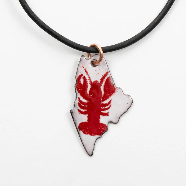 Blueberry Bay Jewelry white state of Maine copper enameled necklace hangs from a black leather cord with a red lobster design