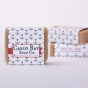 Bar of Casco Bay Soap Co. Oats and Honey Bar Soap with natural ingredients, showcasing a rustic, handcrafted look in a close-up shot.