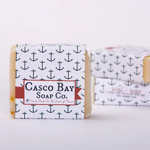 Bar of Casco Bay Bar Soap by Casco Bay Soap Co. with wind and water design on the packaging.