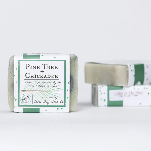 Casco Bay Soap Company bar of cabin in the pines soap with pine tree + chickadee design wrap