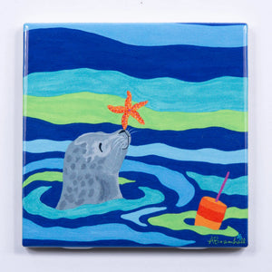 Festive Fish tile coaster featuring a starfish seal design, perfect for holiday decor and protecting surfaces.