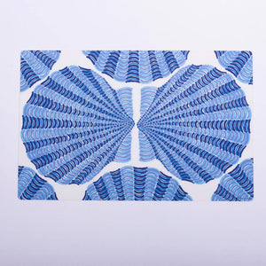 Blue scallop-patterned Festive Fish festive placemat featuring vibrant ocean-inspired design for holiday table settings.