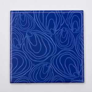 Blue ceramic festive trivet featuring oyster design by Festive Fish, ideal for protecting surfaces during holiday meals.
