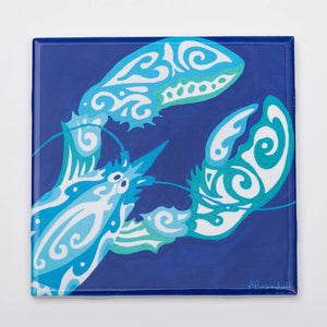 Festive Fish Maori Lobster trivet featuring colorful lobster design on a ceramic surface for kitchen decor and hot dish protection.
