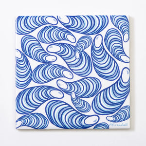 Festive Fish brand trivet featuring a colorful illustration of mussels on a white background for holiday table decor