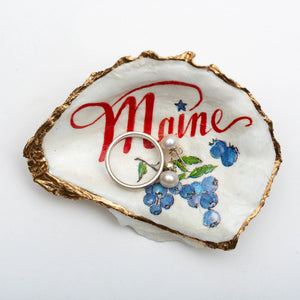 Blue Maine oyster shell ring dish by Latitude 43 Designs with blueberries, showcasing a natural, handcrafted jewelry holder.