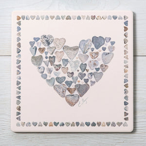 Love Rocks Me heart-shaped trivets featuring a pattern of small hearts, designed to protect surfaces from hot dishes.
