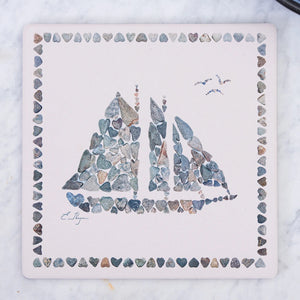 Love Rocks Me trivet featuring a nautical schooner design, made of durable, heat-resistant material for kitchen and dining use.