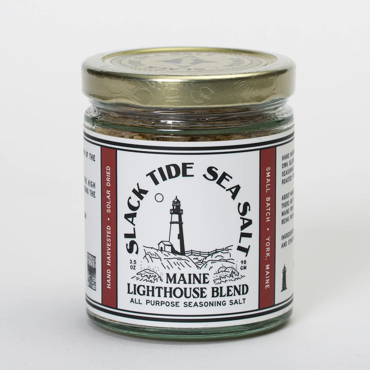 Maine Sea Salt Blend by Slack Tide Maine featuring a lighthouse on the packaging, showcasing natural sea salt for culinary use.