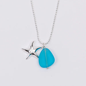 Sea glass necklace by Valerie Paul featuring a starfish charm, showcasing a delicate glass pendant on a silver chain.