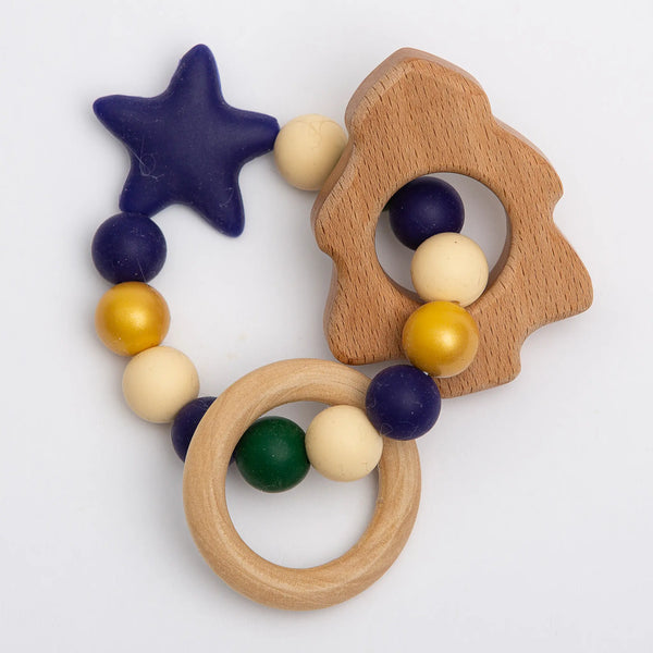 Baloo Baleerie pine tree shaped wooden teether with ring of silicone beads in navy, gold, cream, dark green, and navy star shaped bead with a wooden teething ring attached
