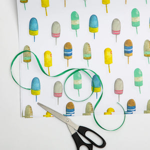 Watercolor gift wraps with buoy and nautical designs by Emmy + Olly, perfect for wrapping gifts with a seaside theme.