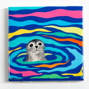 Festive Fish tile coaster featuring a harbor seal design, showcasing a colorful and festive marine animal illustration.