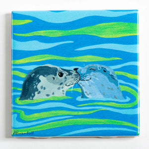 Festive Fish tile coaster featuring two playful seals, colorful holiday-themed design, perfect for protecting surfaces during celebrations.