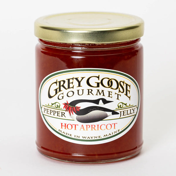Hot Apricot pepper jelly comes in a clear 9 oz glass jar and is a bright red orange color