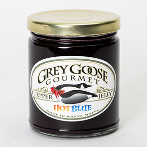 Hot Blue pepper jelly comes in a clear 9 oz glass jar and is a dark purple color