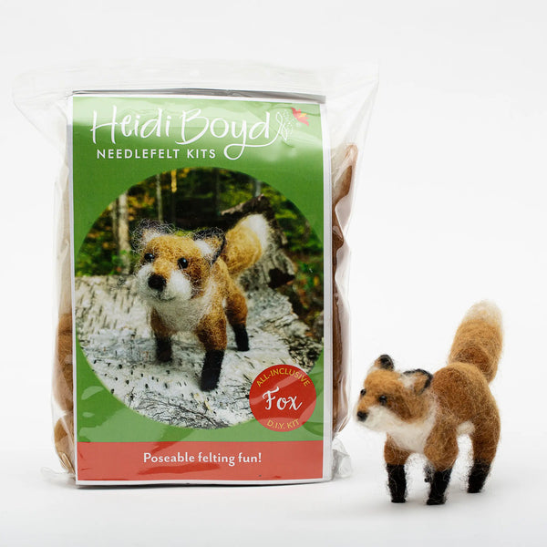 Poseable fox needlefelt kit in clear plastic package next to completed example