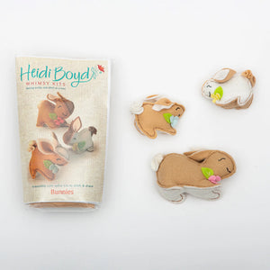 Heidi Boyd Whimsy Felt Kit featuring adorable bunnies with colorful felt pieces and crafting tools for creating cute felt figures.