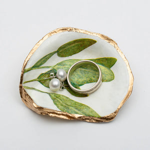 Sage green oyster shell ring dish by Latitude 43 Designs, showcasing a natural oyster shell with smooth interior for jewelry.